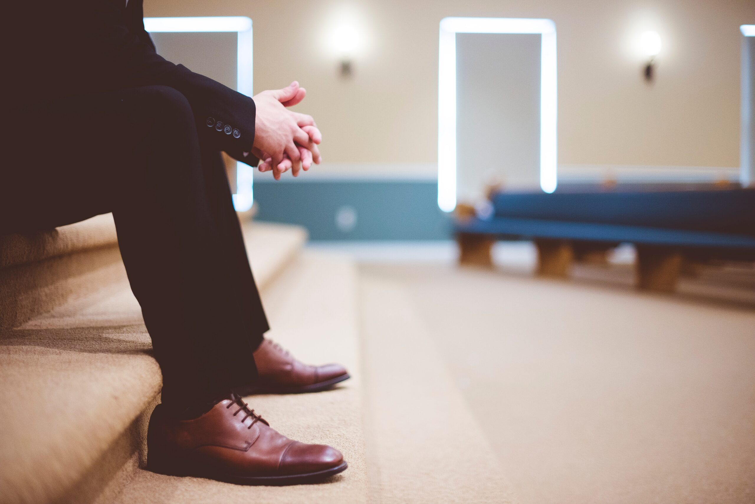 Man sitting in church with folded hands