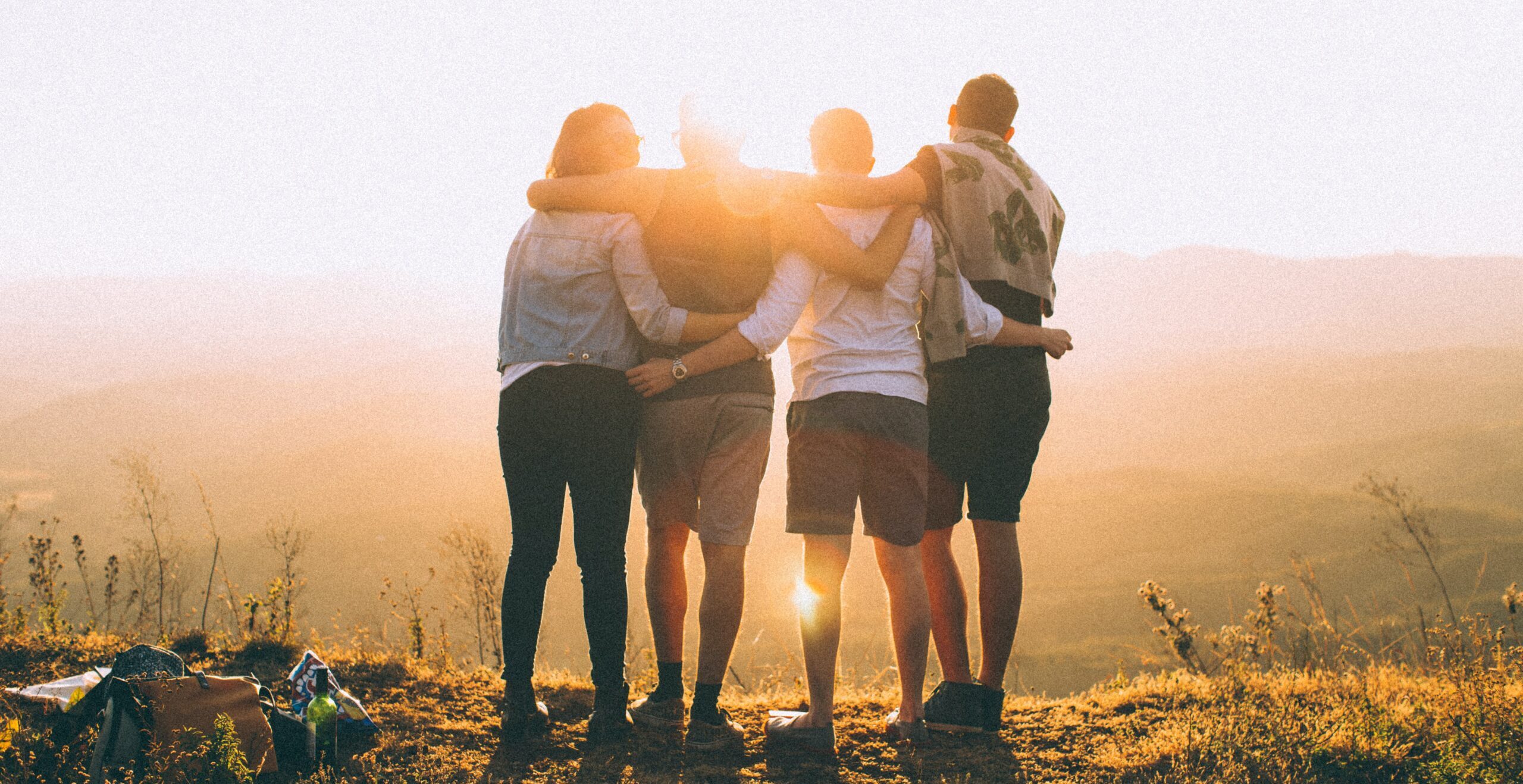 Group of four people watching the sunset