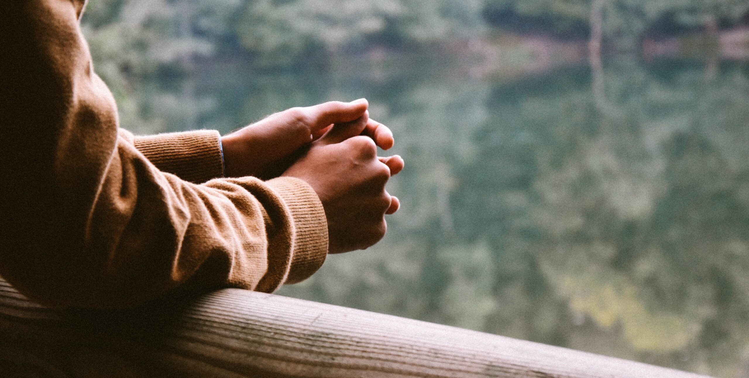 arms resting on railing