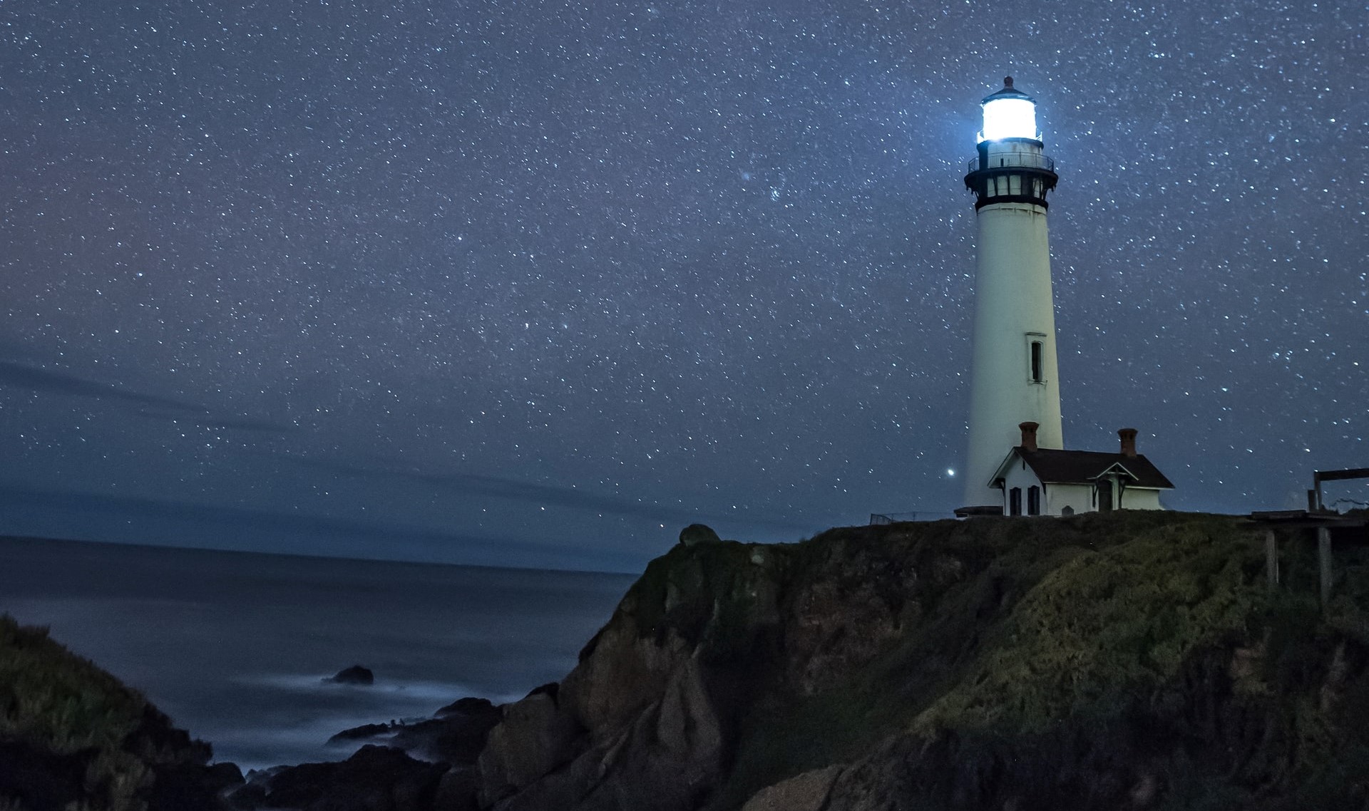 lighthouse lit up at night