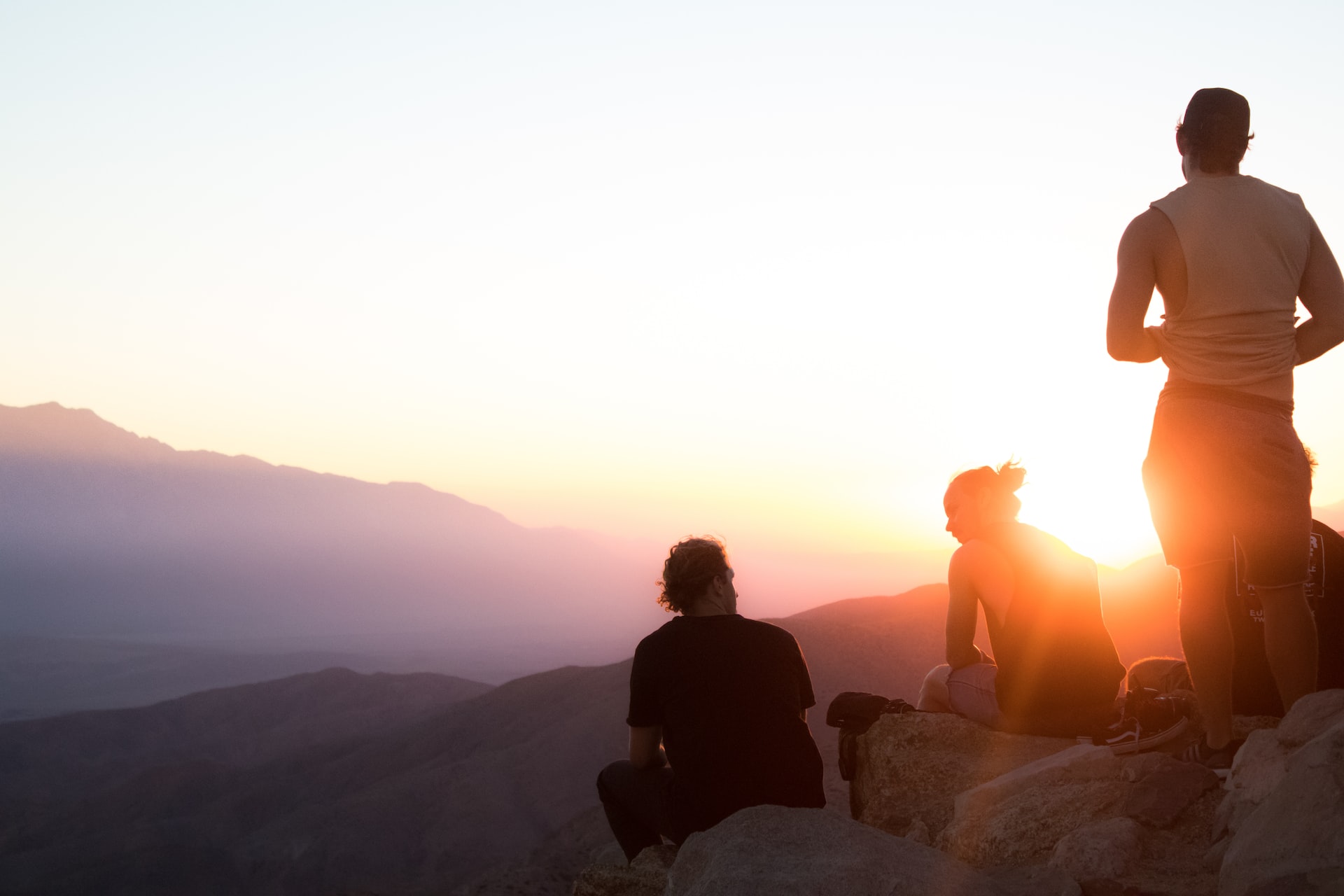 Three friends watching the sunset