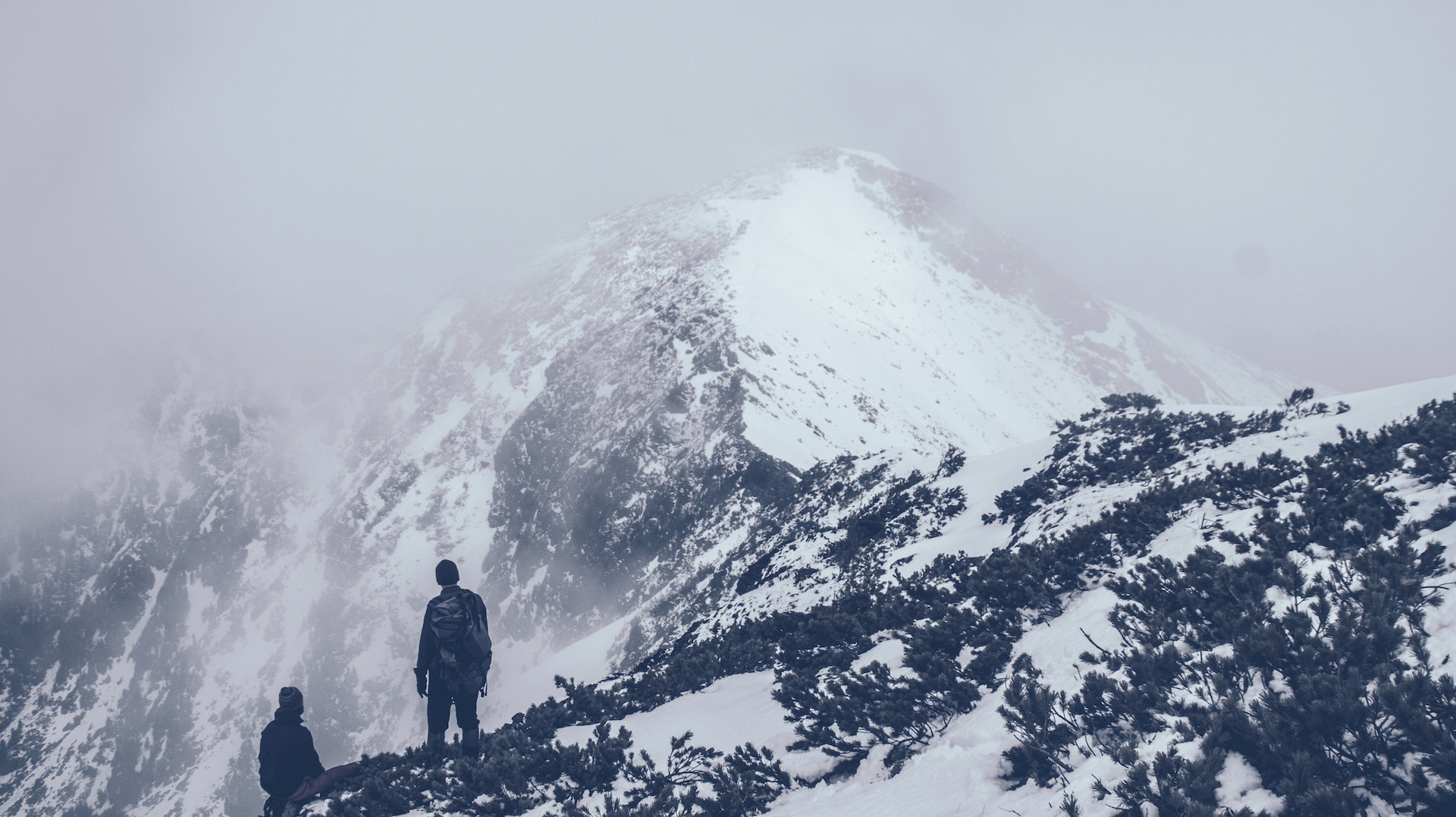 two hikers on a snowy mountain
