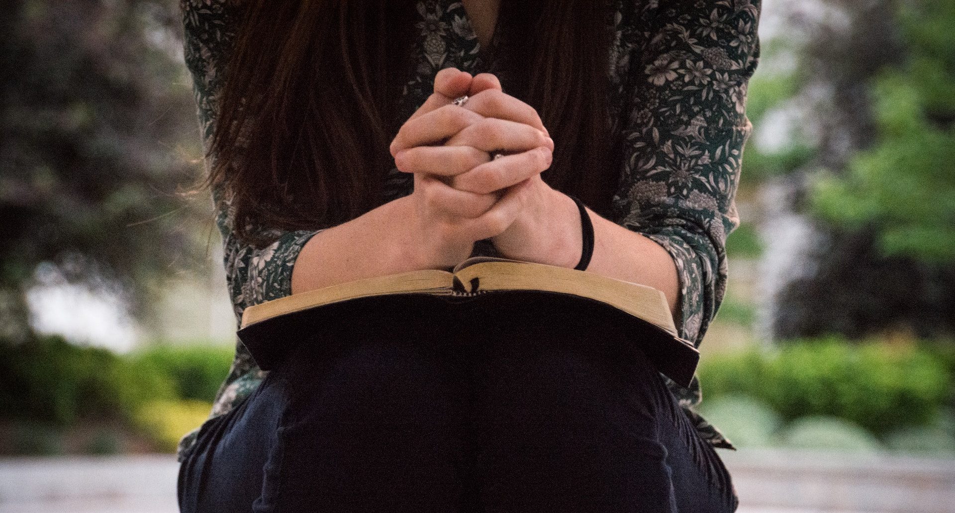 Woman praying with Bible