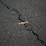 band aid on crack in asphalt