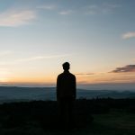 silhouette of man against the sea