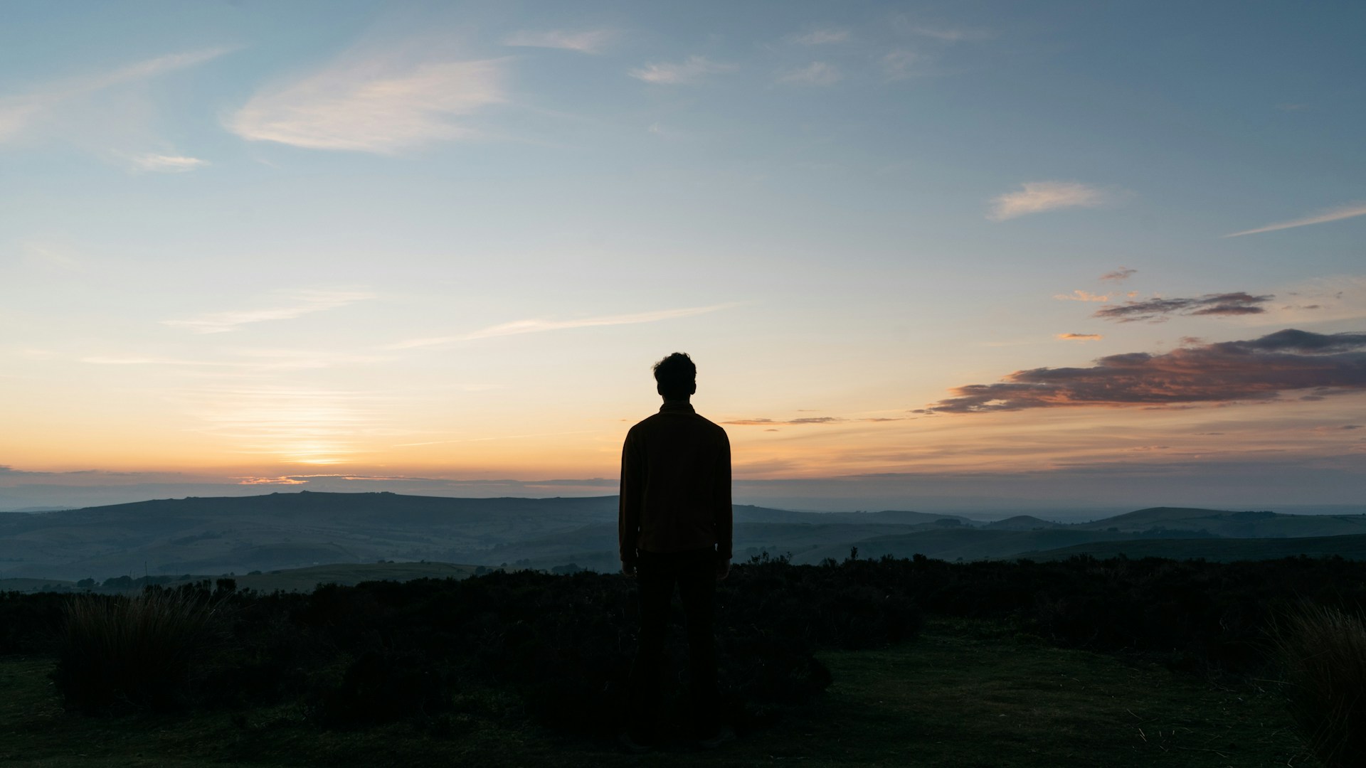 silhouette of man against the sea